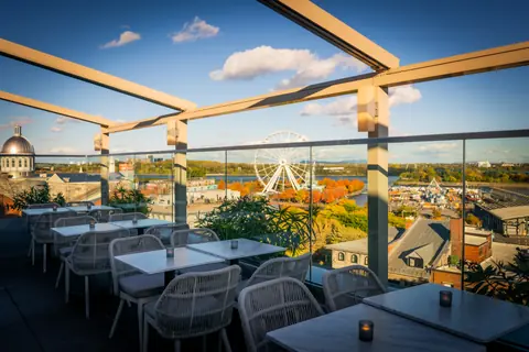 Rooftop terrace overlooking the Bonsecours Market dome, the Old Port Ferris wheel and the St. Lawrence River in Montreal