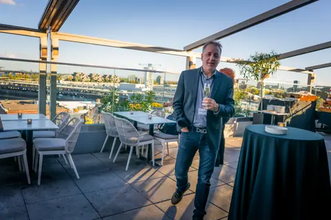 Guest walking across the rooftop terrace with Old Montreal in the background