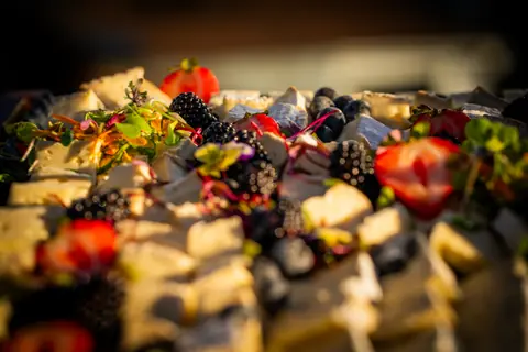 Close-up of berries and cheese on the grazing display