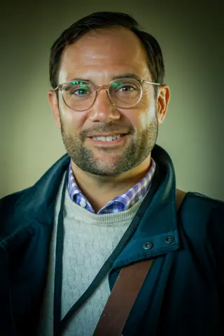 Portrait of a smiling attendee in glasses at the Montreal event