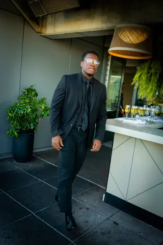 Guest in a dark suit walking onto the terrace