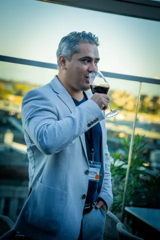 Attendee sipping red wine on the terrace