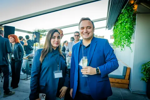 Two guests posing together on the crowded terrace