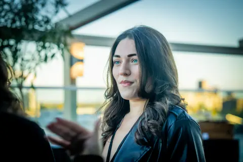 Attendee listening during a conversation at sunset