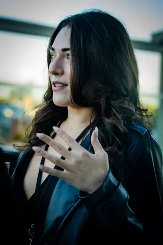 Attendee gesturing while speaking with guests