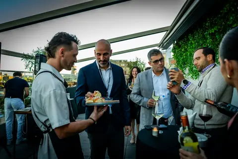 Server offering canapés to a group of attendees