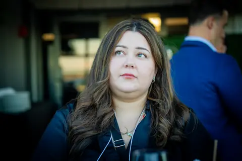 Attendee listening during a conversation at dusk