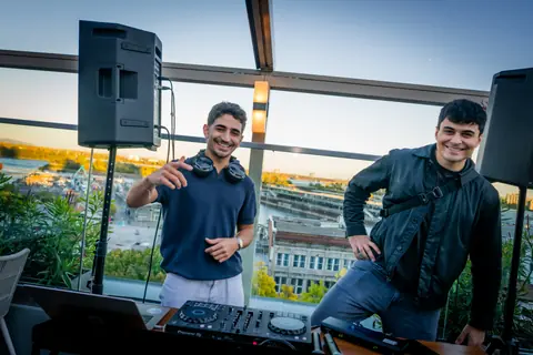 Two guests posing at the DJ booth overlooking the Old Port