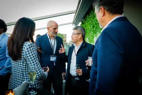 Group of multifamily professionals in conversation on the terrace