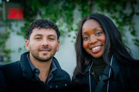 Two attendees smiling together at the ElevateOS networking event