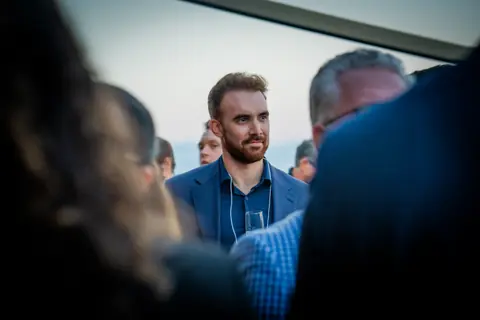 Attendee in the middle of a group conversation on the terrace