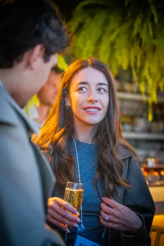 Attendee smiling with a glass of champagne