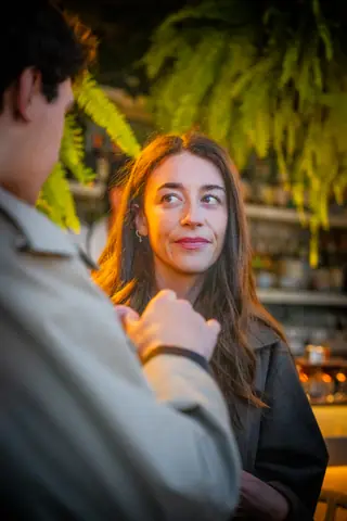 Guest glancing toward the camera during a conversation by the bar