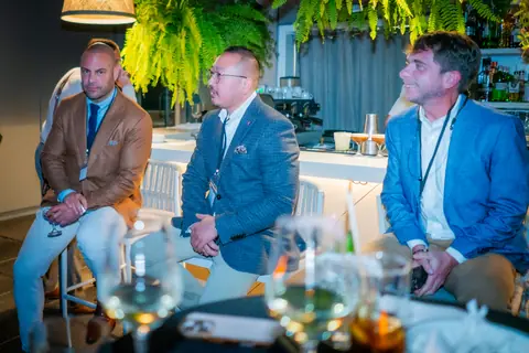 Three panelists listening from their stools during the discussion