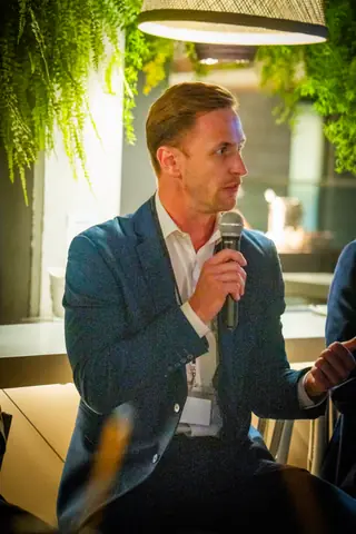 Panelist speaking into a microphone during the discussion