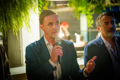 Two panelists sharing the microphone during the discussion