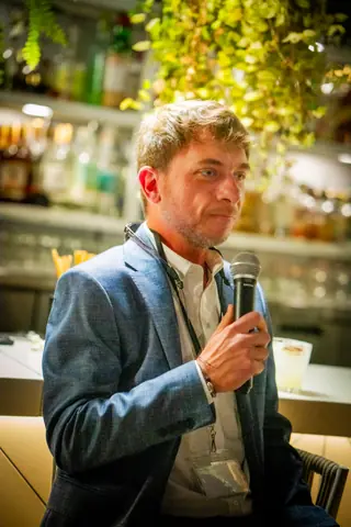 Panelist holding the microphone while he speaks
