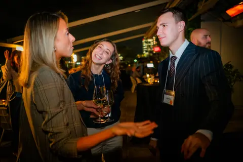 Attendees in an animated conversation late in the evening