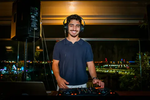 DJ smiling behind the decks at the end of the night
