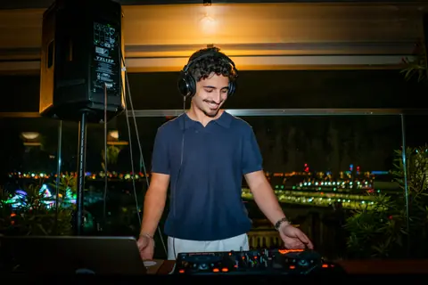 DJ looking up from the mixer during his set