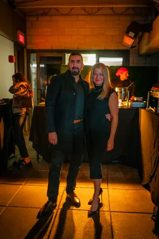 Two attendees posing by the entrance at the end of the evening
