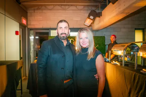 Two attendees posing together near the end of the event